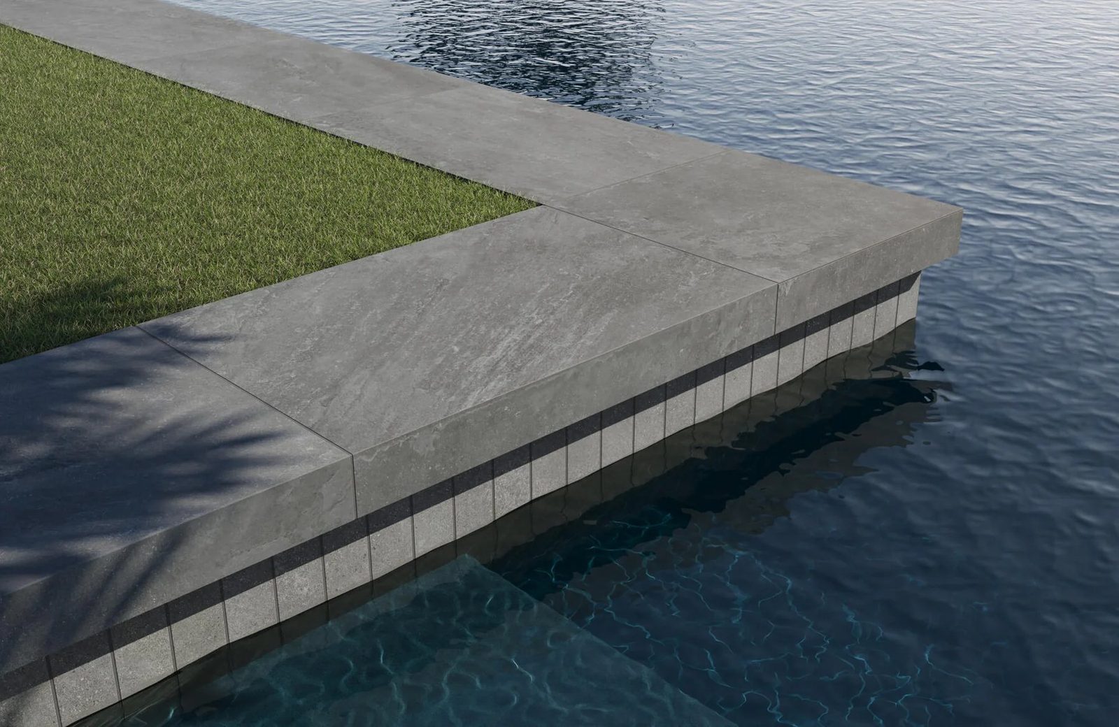 L-shaped porcelain pool coping with waterline tile and pool edge detail.